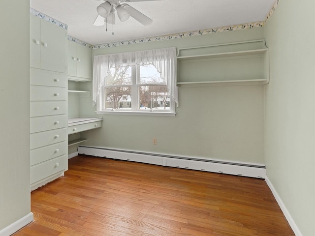 67 Case Pkwy, Burlington, VT 05401 - unfurnished bedroom featuring a baseboard heating unit, light wood-style floors, ceiling fan, and baseboards