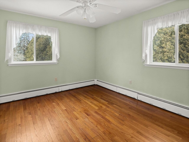 67 Case Pkwy, Burlington, VT 05401 - unfurnished room featuring baseboard heating, ceiling fan, and wood finished floors