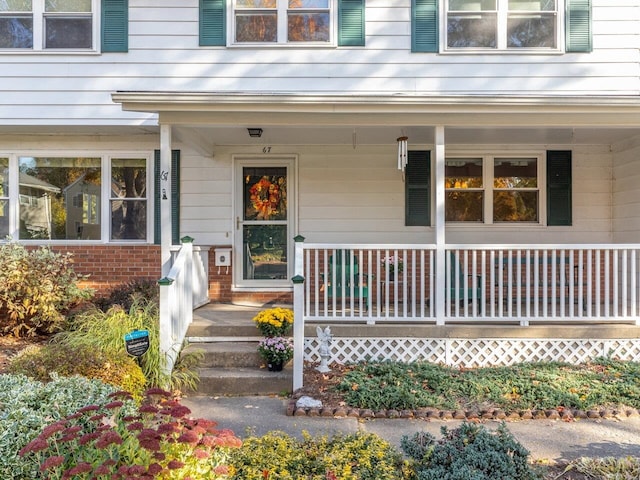 67 Case Pkwy, Burlington, VT 05401 - doorway to property featuring a porch and brick siding