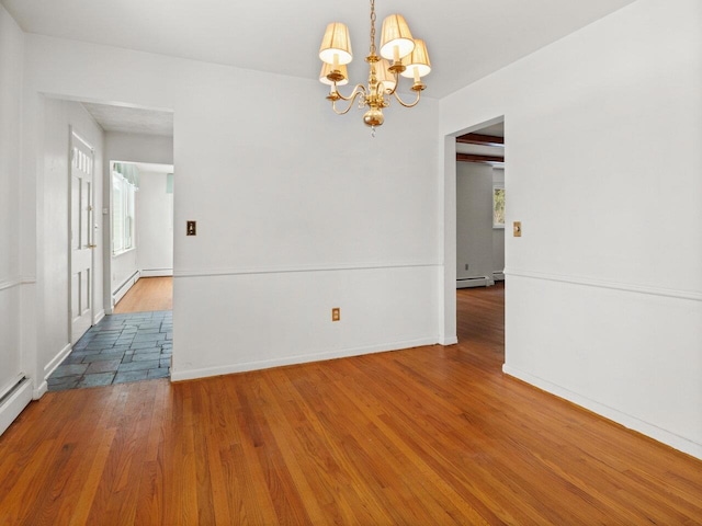 67 Case Pkwy, Burlington, VT 05401 - spare room featuring a chandelier, healthy amount of natural light, wood finished floors, and a baseboard heating unit