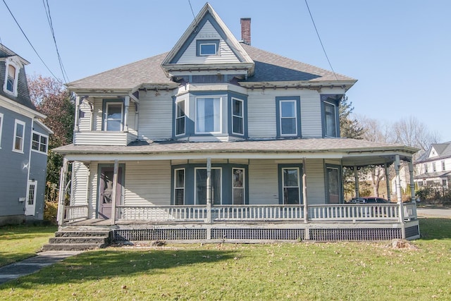 43 Maple St, Orleans, VT 06860 - victorian home with covered porch, a front yard, a chimney, and a shingled roof