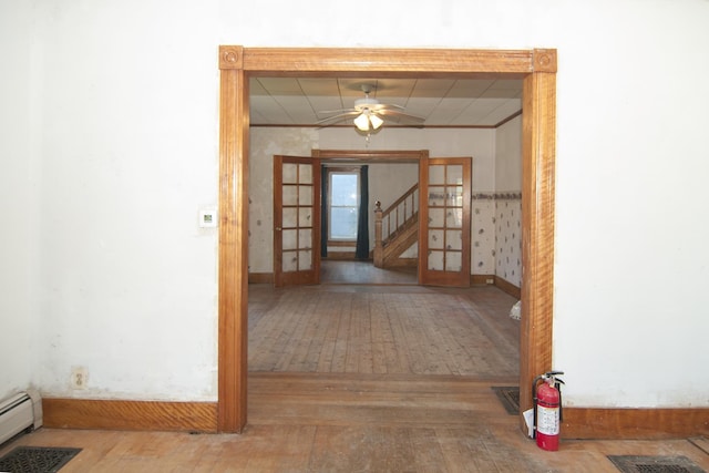 43 Maple St, Orleans, VT 06860 - hall featuring hardwood / wood-style flooring, stairs, french doors, baseboards, and a baseboard radiator