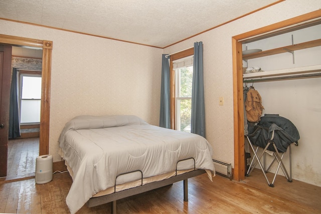 43 Maple St, Orleans, VT 06860 - bedroom featuring ornamental molding, hardwood / wood-style flooring, and baseboard heating