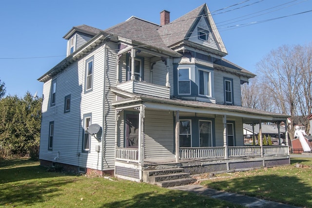 43 Maple St, Orleans, VT 06860 - victorian-style house with covered porch, a front lawn, and a chimney