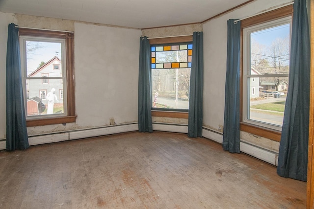 43 Maple St, Orleans, VT 06860 - spare room featuring wood finished floors, ornamental molding, and a baseboard radiator