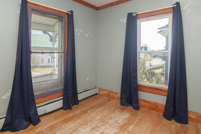 43 Maple St, Orleans, VT 06860 - unfurnished room with wood finished floors, healthy amount of natural light, and baseboards