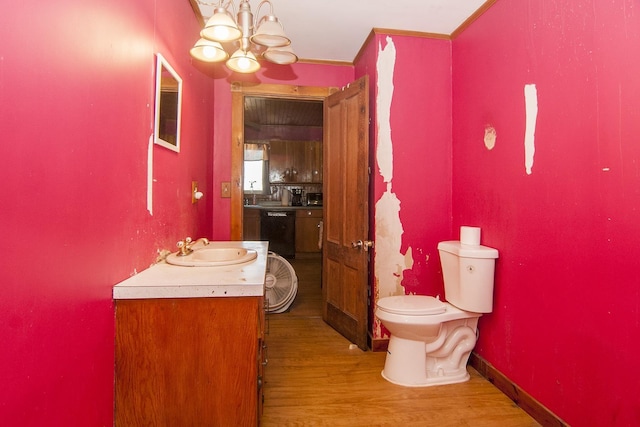 43 Maple St, Orleans, VT 06860 - bathroom with a chandelier, vanity, wood finished floors, and toilet