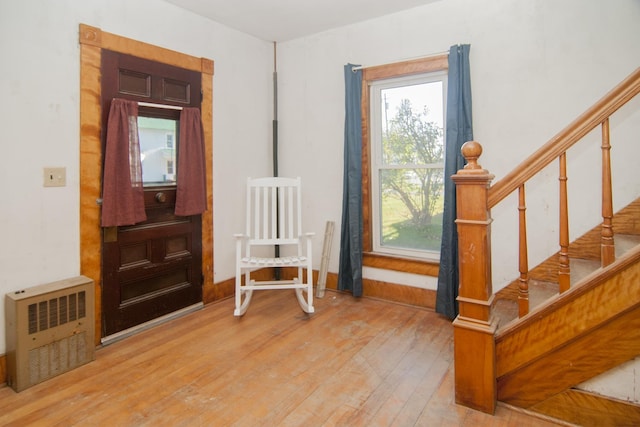 43 Maple St, Orleans, VT 06860 - foyer entrance featuring wood finished floors, stairs, and heating unit
