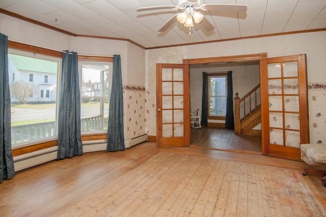 43 Maple St, Orleans, VT 06860 - empty room with hardwood / wood-style flooring, crown molding, plenty of natural light, a ceiling fan, and french doors