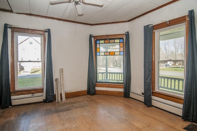 43 Maple St, Orleans, VT 06860 - unfurnished room with a baseboard heating unit, hardwood / wood-style flooring, ceiling fan, and ornamental molding