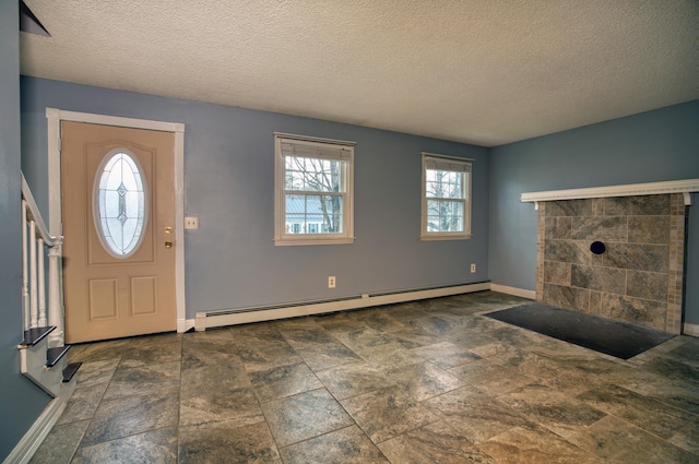 foyer entrance with a baseboard radiator and a textured ceiling