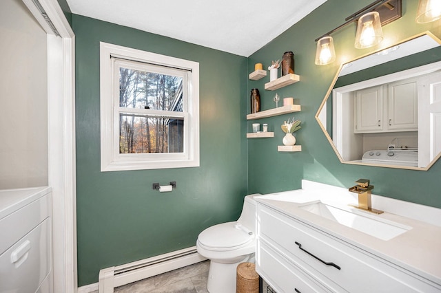 bathroom with a baseboard heating unit, tile patterned flooring, washer and clothes dryer, and toilet