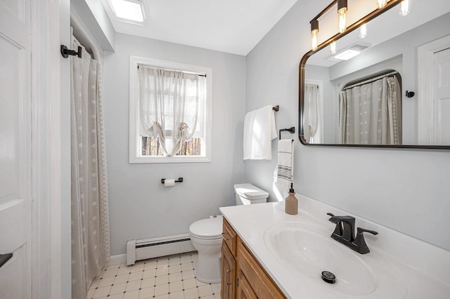 bathroom featuring baseboard heating, tile patterned flooring, vanity, and toilet