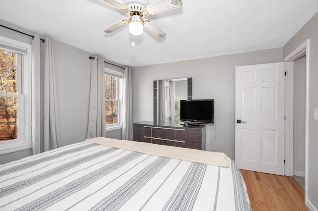 unfurnished bedroom with light wood-type flooring and ceiling fan