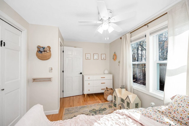 bedroom featuring a closet, light wood-type flooring, and ceiling fan