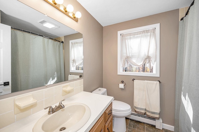 bathroom with a baseboard heating unit, vanity, and toilet