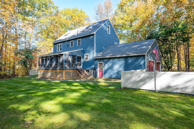 back of property with a sunroom and a yard