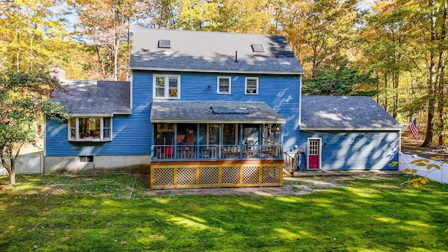 rear view of property featuring a lawn and a sunroom