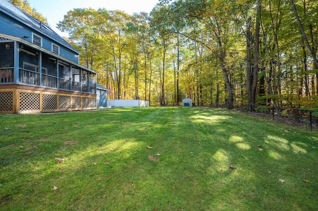 view of yard featuring a storage unit and a sunroom