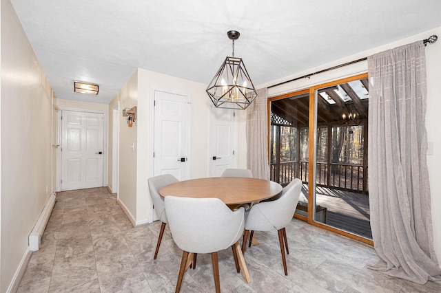 dining room with an inviting chandelier and a baseboard heating unit