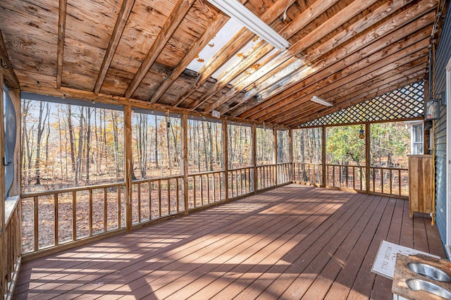 unfurnished sunroom featuring lofted ceiling