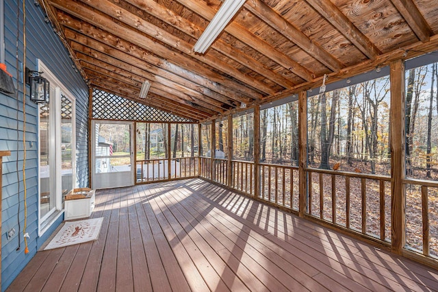 unfurnished sunroom featuring vaulted ceiling