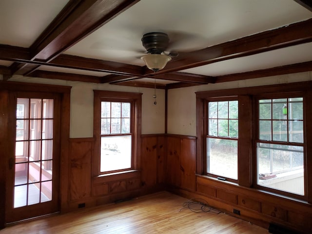 empty room with light wood-type flooring, plenty of natural light, and ceiling fan