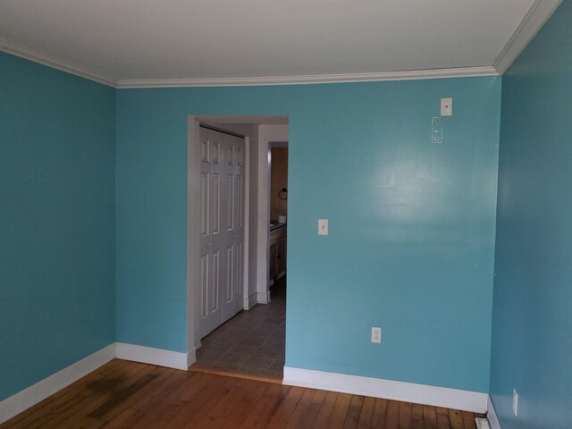 unfurnished room featuring hardwood / wood-style flooring and ornamental molding