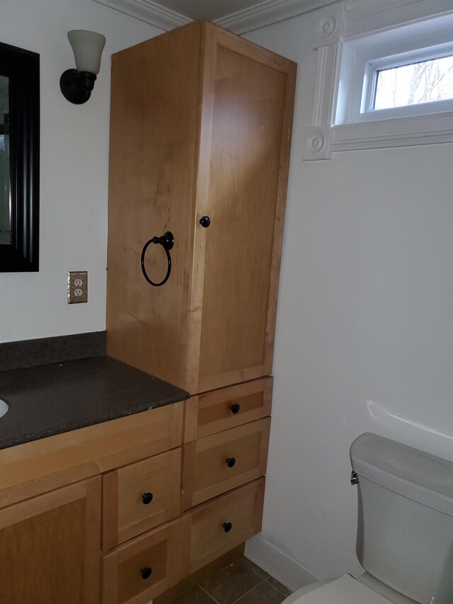 bathroom with vanity, tile patterned flooring, and toilet