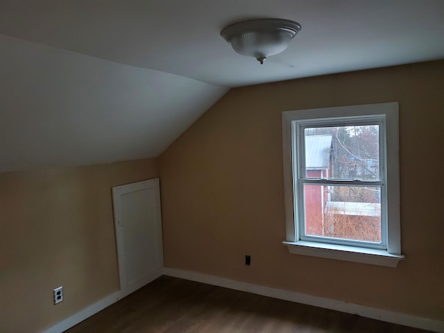 bonus room featuring dark hardwood / wood-style flooring and lofted ceiling