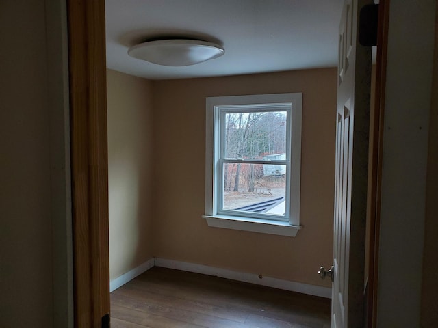 unfurnished room with hardwood / wood-style floors