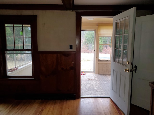 entryway featuring light wood-type flooring and beam ceiling