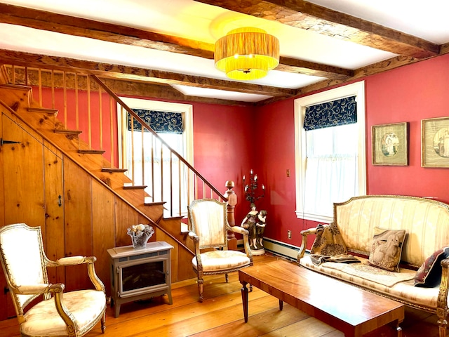 living area with beam ceiling and light hardwood / wood-style flooring