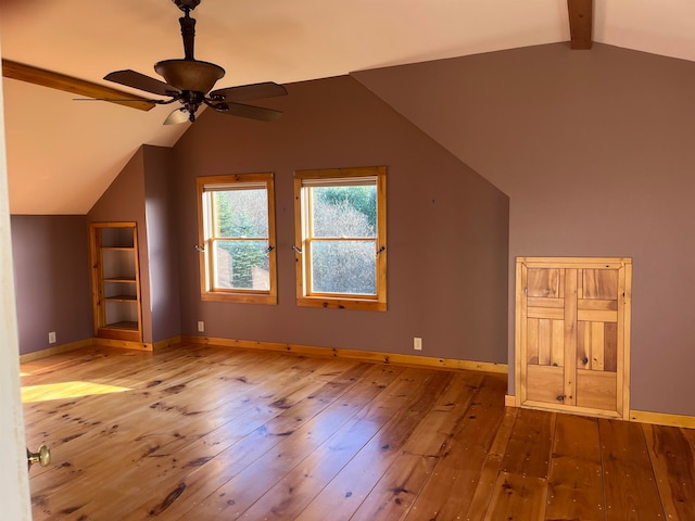 bonus room featuring ceiling fan, light hardwood / wood-style flooring, and lofted ceiling with beams