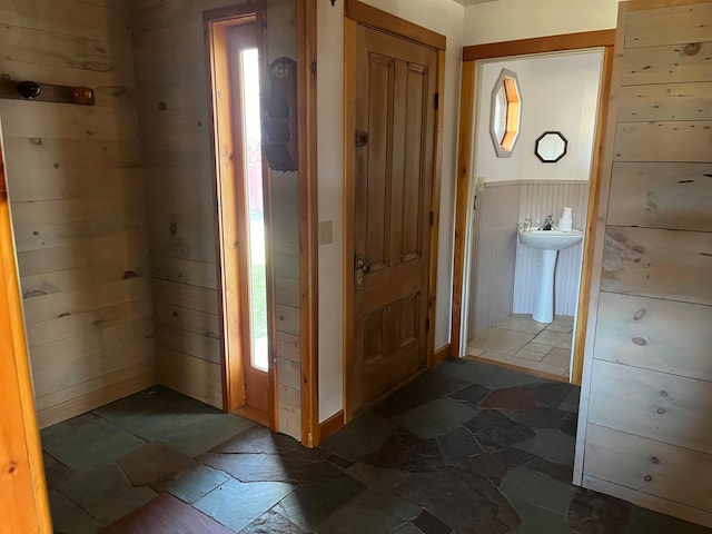 interior space featuring wooden walls and sink