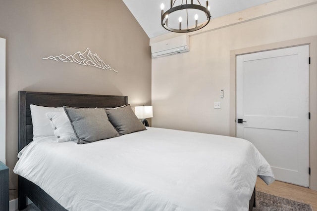 bedroom featuring a chandelier, a wall unit AC, vaulted ceiling, and hardwood / wood-style flooring