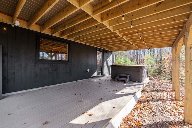 wooden deck with a hot tub