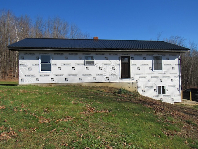 view of side of home with a lawn