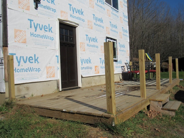 view of exterior entry with a wooden deck