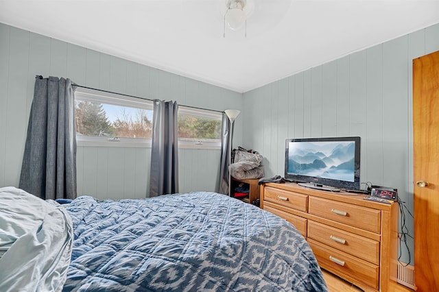 bedroom with wood walls