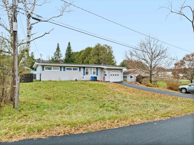 ranch-style home featuring a garage and a front yard