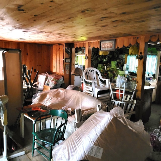 misc room featuring a healthy amount of sunlight, wood ceiling, and wood walls