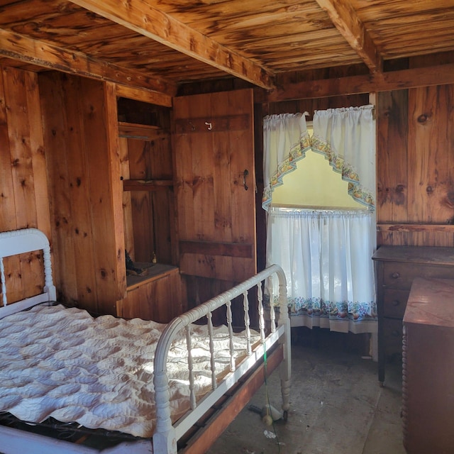 bedroom featuring beamed ceiling, wooden ceiling, and wood walls