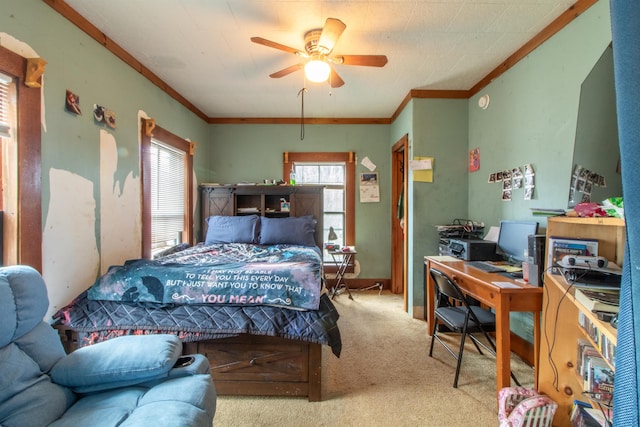 carpeted bedroom featuring ceiling fan and crown molding