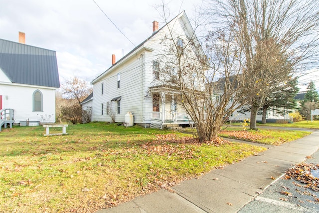 view of property exterior with a yard