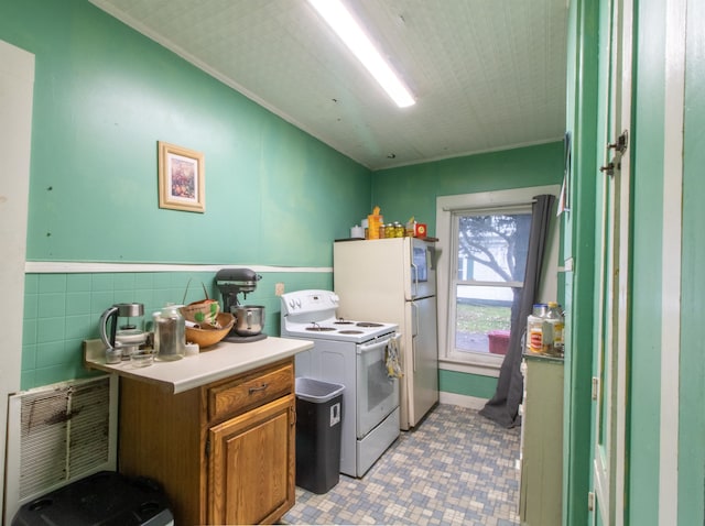 laundry area with tile walls