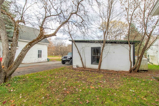 view of property exterior featuring a lawn