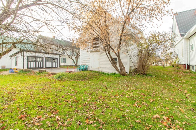 view of yard with a sunroom and a patio area