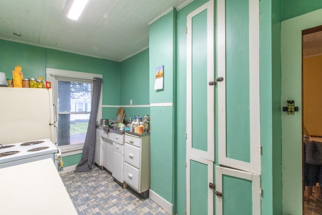 kitchen with white appliances and ornamental molding