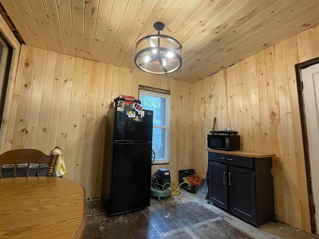 kitchen featuring black appliances, wood walls, dark hardwood / wood-style flooring, and wooden ceiling